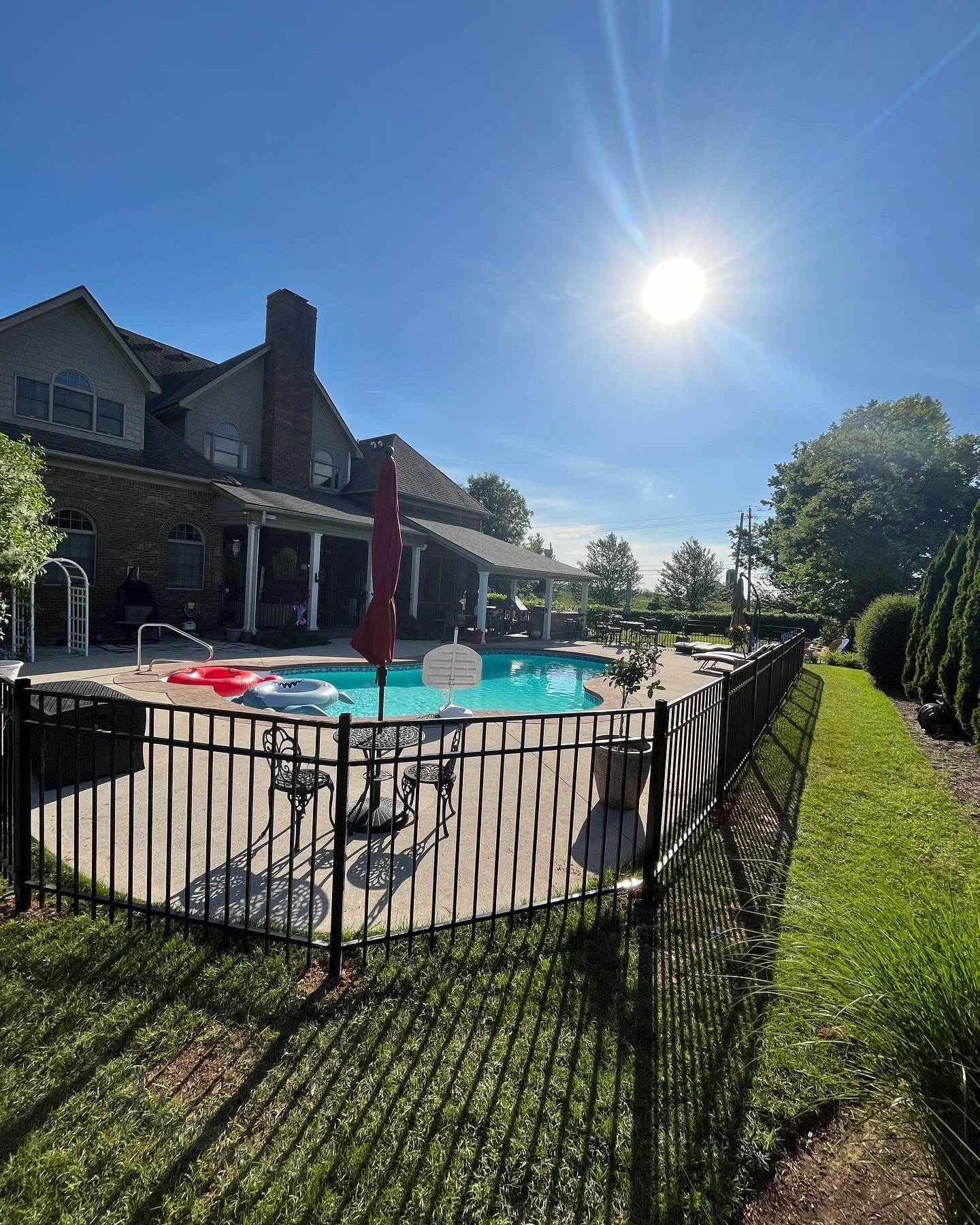 A large house with a swimming pool behind a fence – Lexington, KY - Chafin Fence LLC