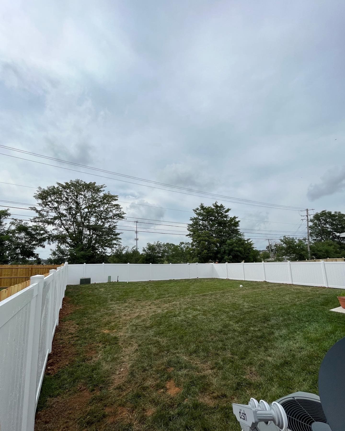 a large lawn with a white fence and trees in the background — Lexington, KY — Chafin Fence LLC