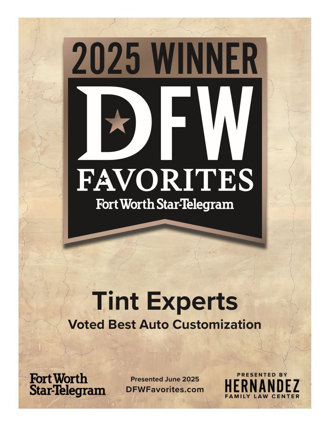 An old car is parked in a garage with its doors open