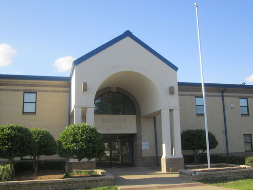 A large brick building with a flag in front of it