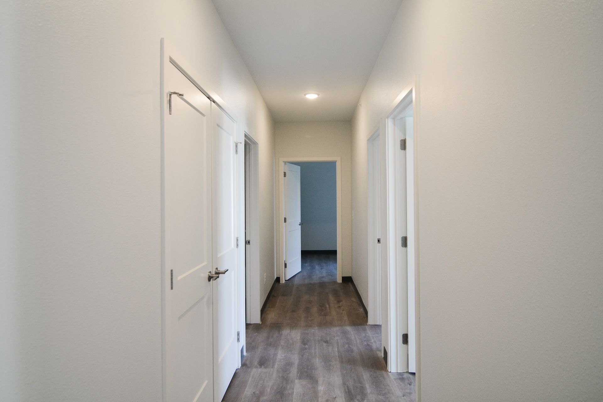 Dog-Friendly Affordable Apartments in Downtown Lincoln, NE - Union at Antelope Valley - Hallway Area Featuring Built-in Lighting and White Walls
