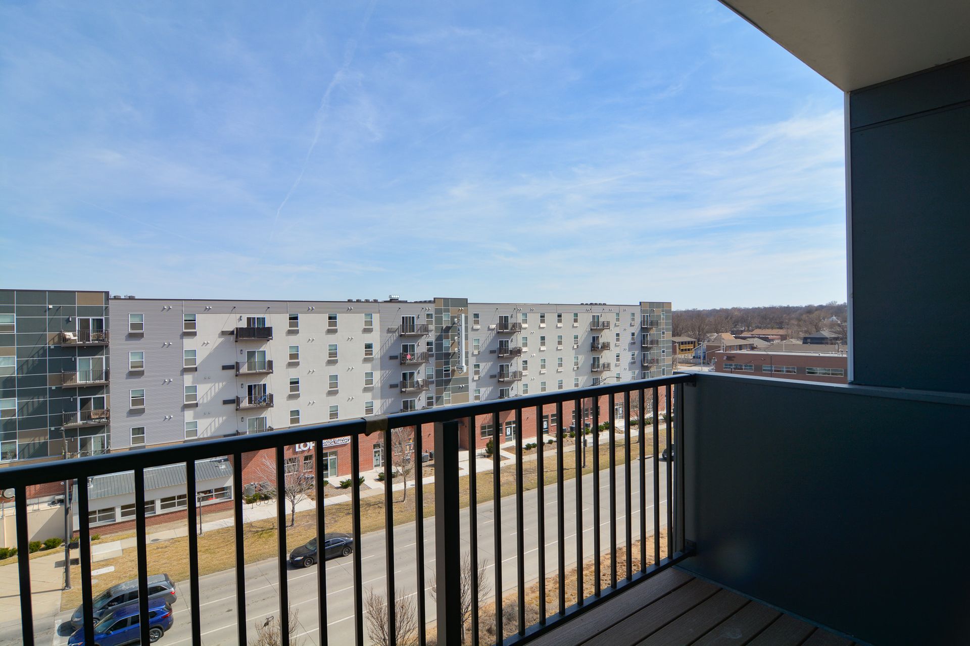 Two-Bedroom Affordable Apartments in Lincoln, NE - Union at Antelope Valley - Patio with Cement Floors, Railing, and Outdoor View