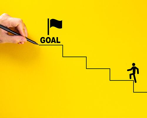 a person is drawing a goal on a yellow wall with a pen .