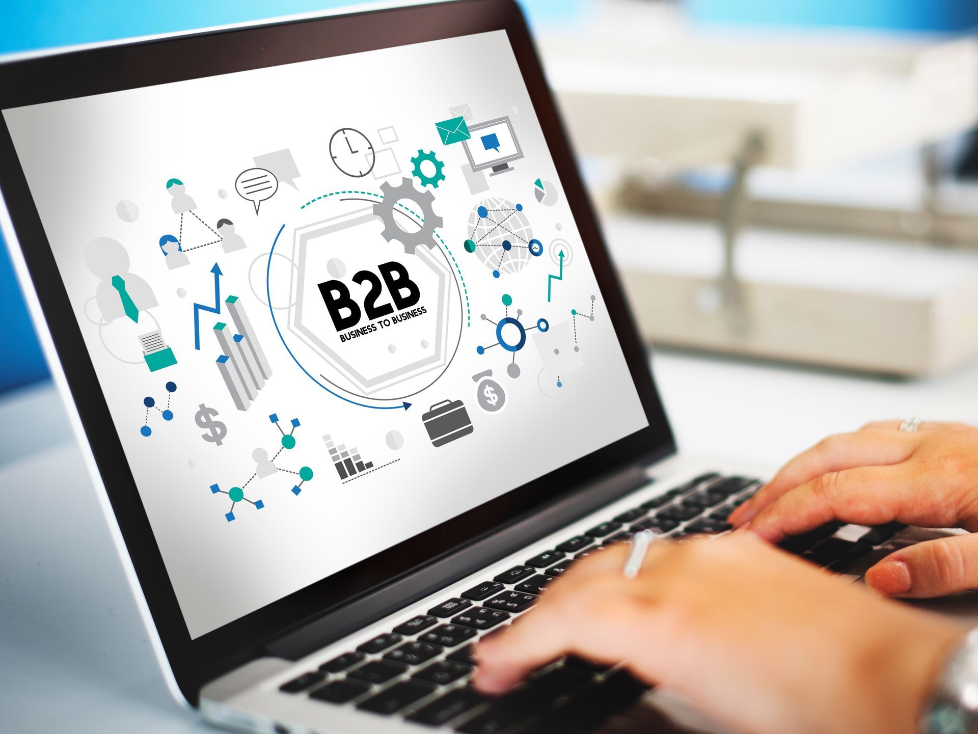 A person is typing on a laptop computer with a b2b concept on the screen.