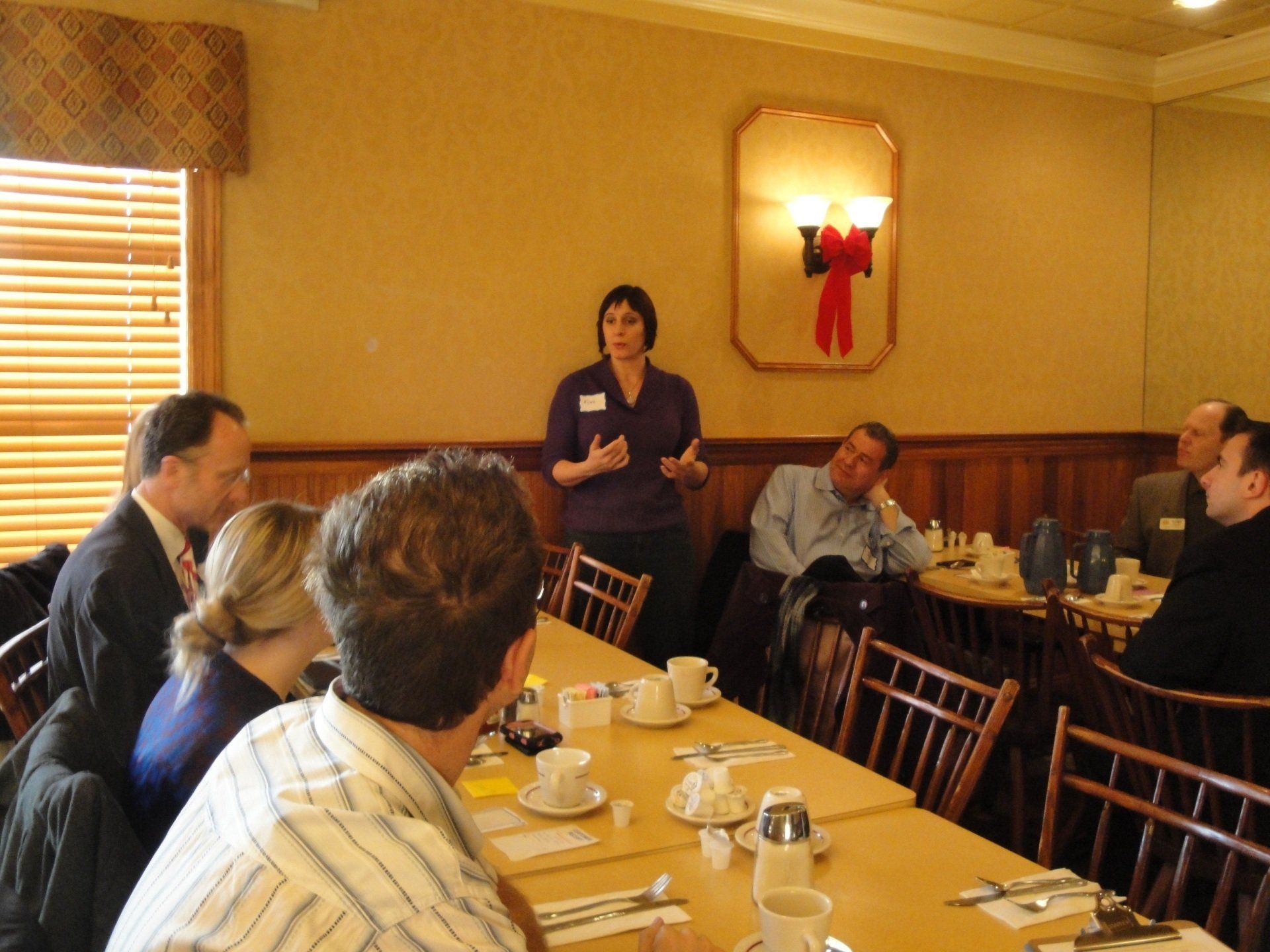 A woman is giving a presentation to a group of people