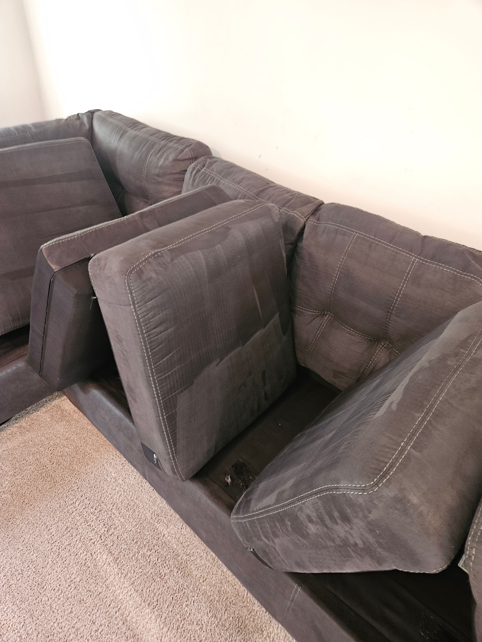 A light and airy living room with neutral-toned furniture, hardwood floors, and large windows.