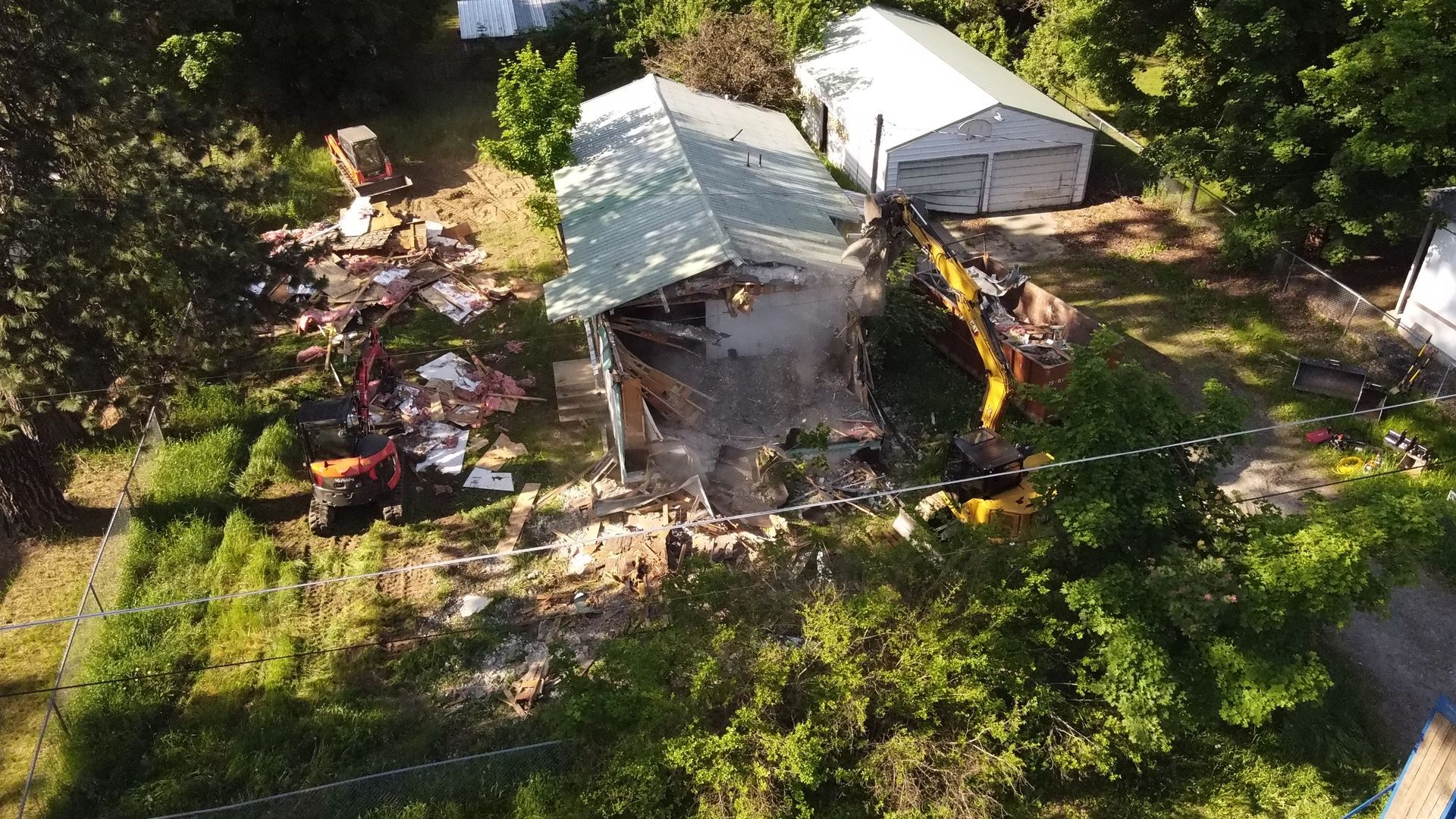 An aerial view of a house that is being demolished.