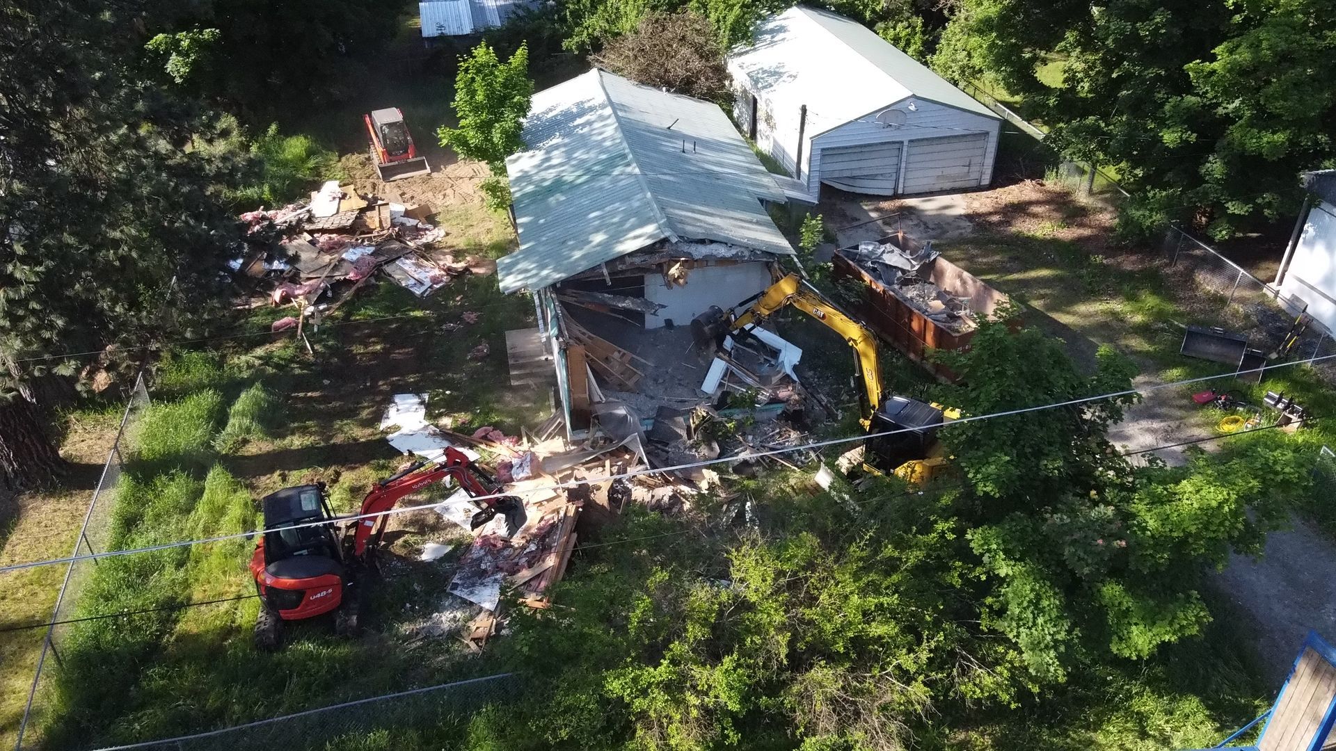 An aerial view of a house being demolished.