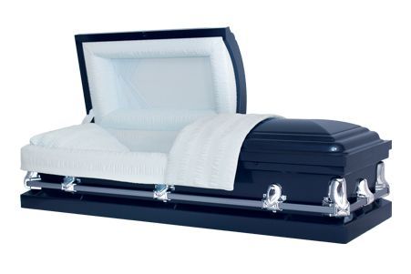 a black coffin with the lid open and a white blanket on it .