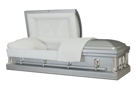 a silver coffin with the lid open and a white blanket on it .