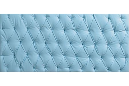 a close up of a light blue tufted headboard on a white background .