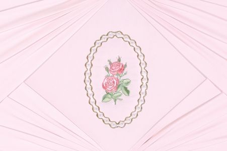 a pink napkin with a picture of roses embroidered on it .