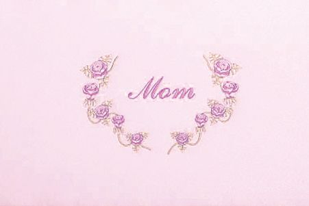 a pink background with a wreath of purple roses and the word mom embroidered on it .