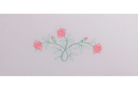 a white envelope with pink flowers embroidered on it .