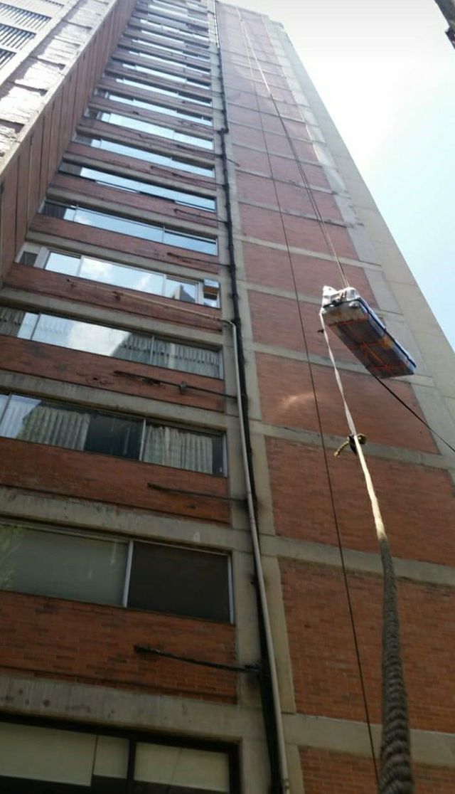 Un edificio muy alto con una grúa adjunta.