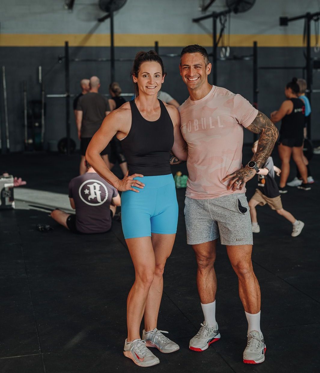 A group of men are posing for a picture in a gym.