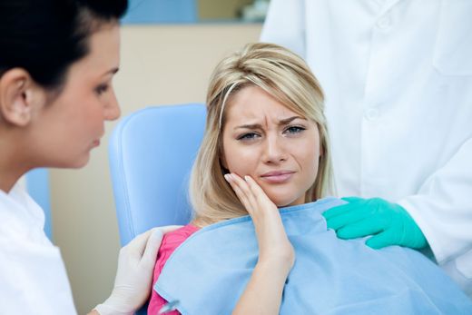 A woman is sitting in a dental chair with a toothache — Hobart, TAS — Moonah Dental Centre