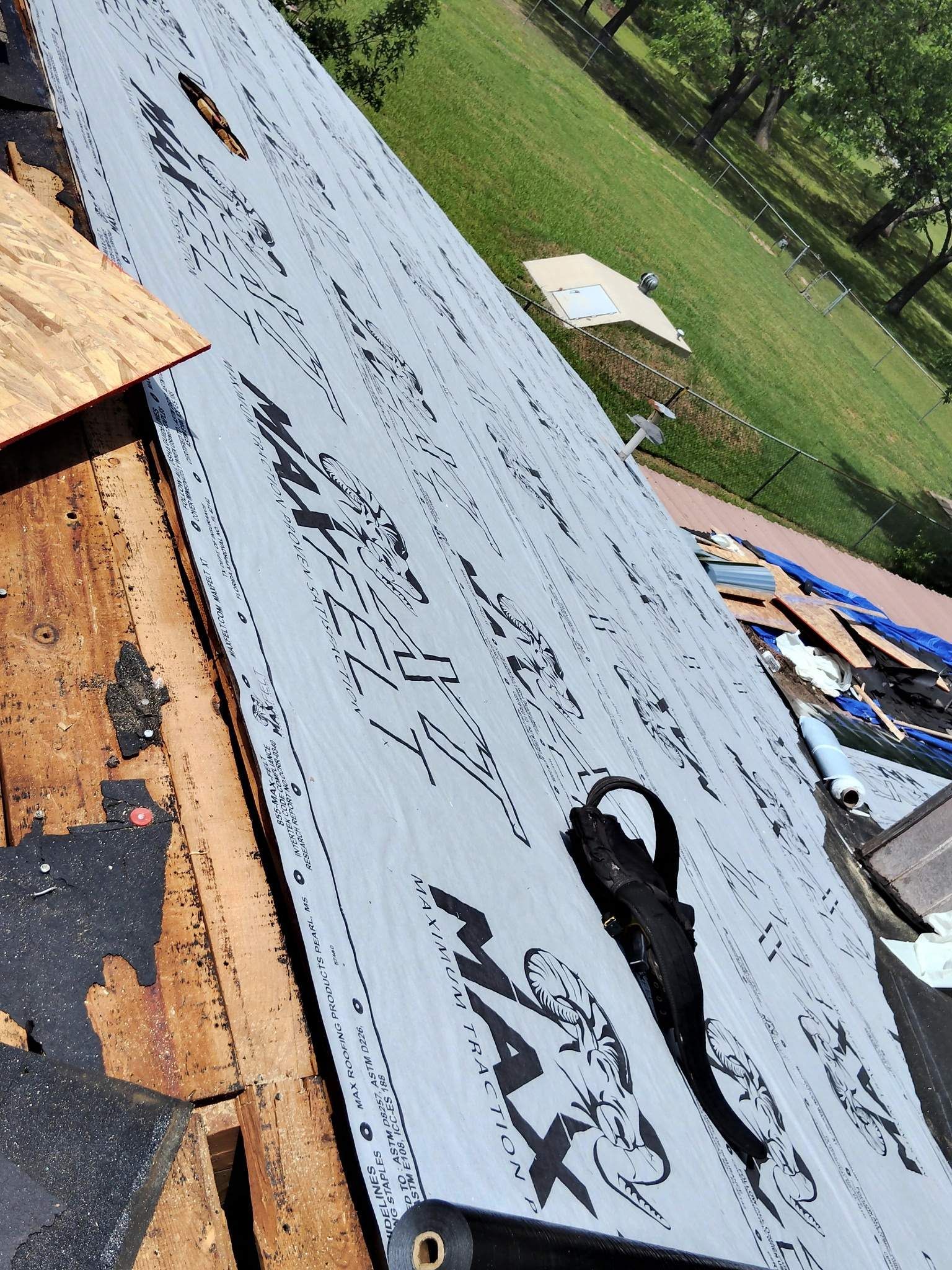 A roof with a lot of shingles on it is being repaired.