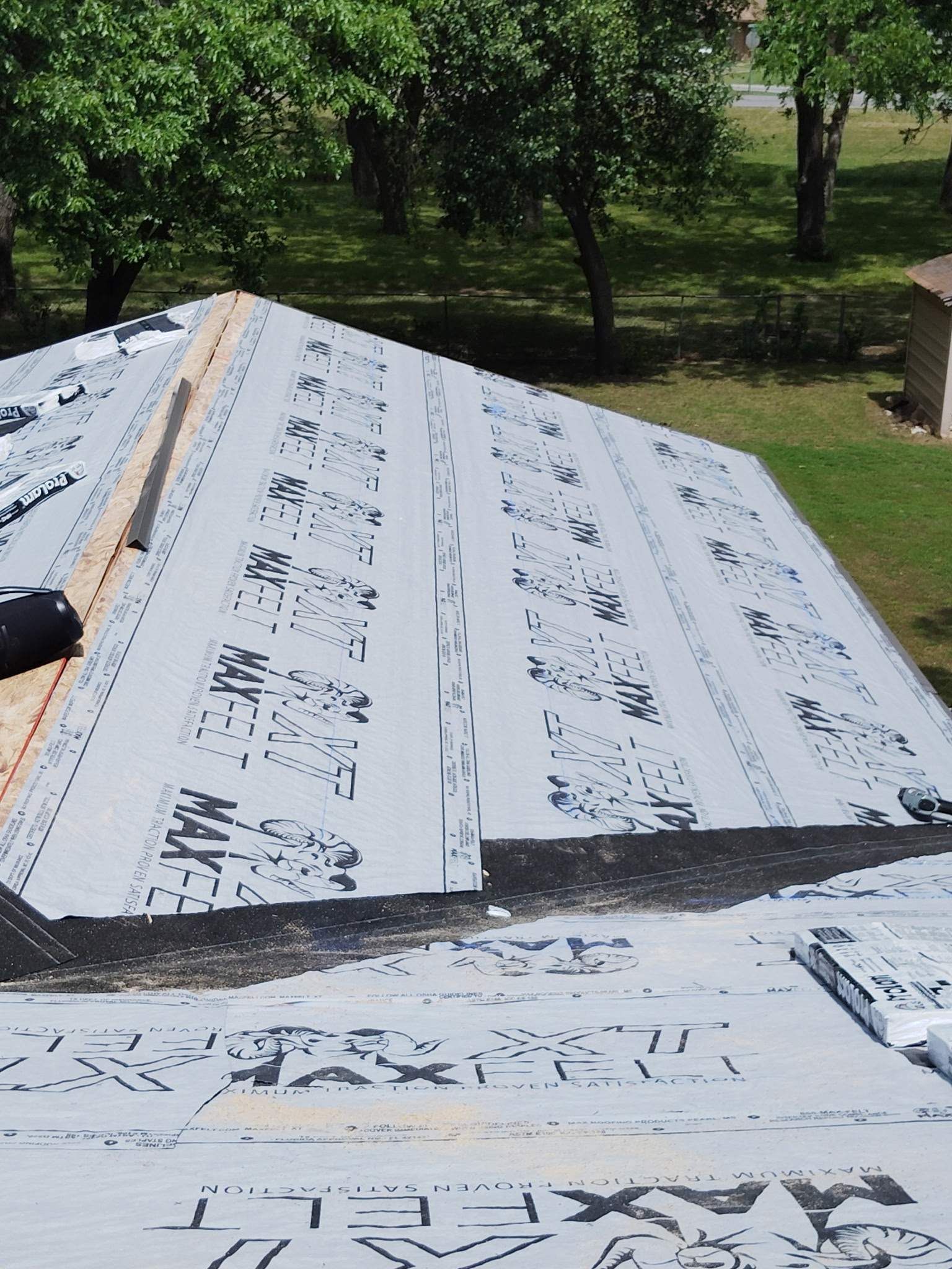 An aerial view of a roof that is being installed