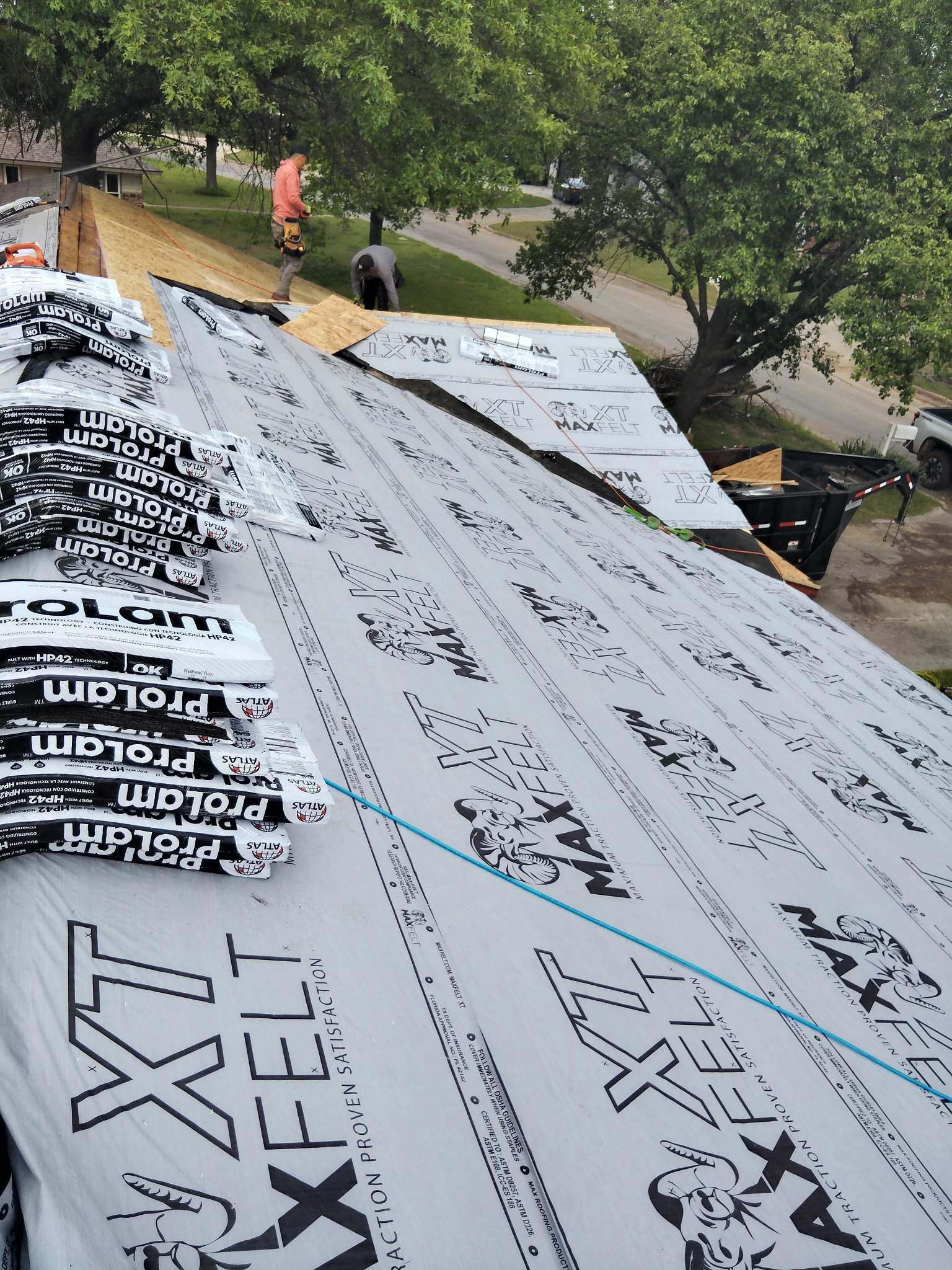 A roof with a lot of roofing material on it.