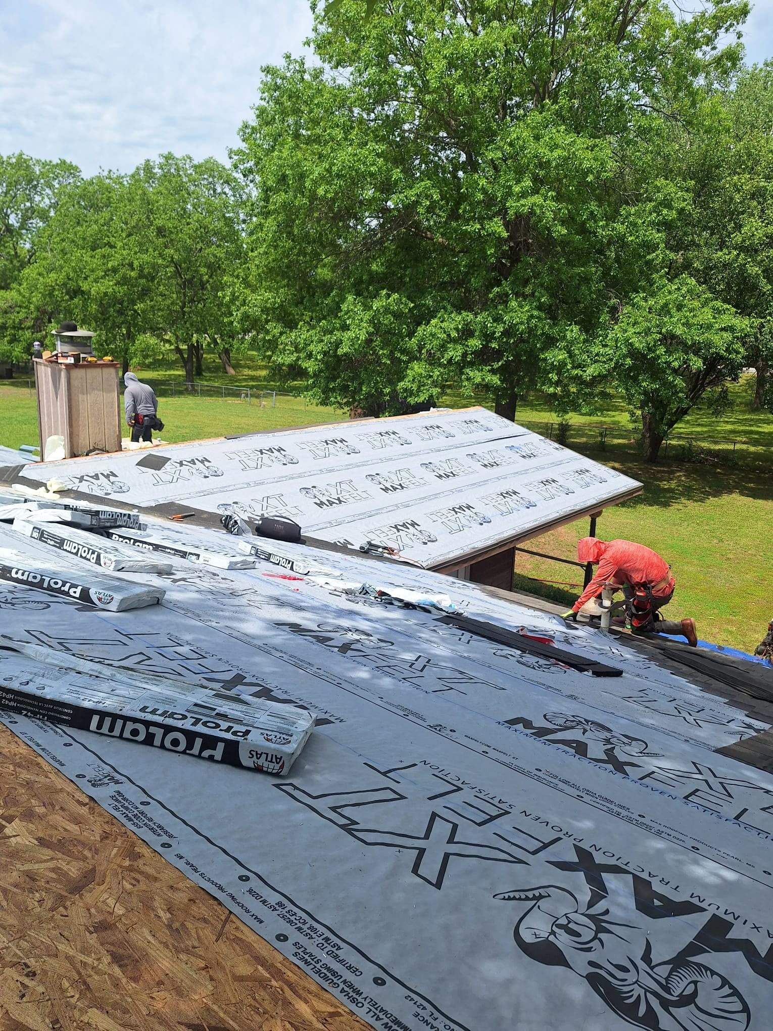 A man is working on the roof of a house.