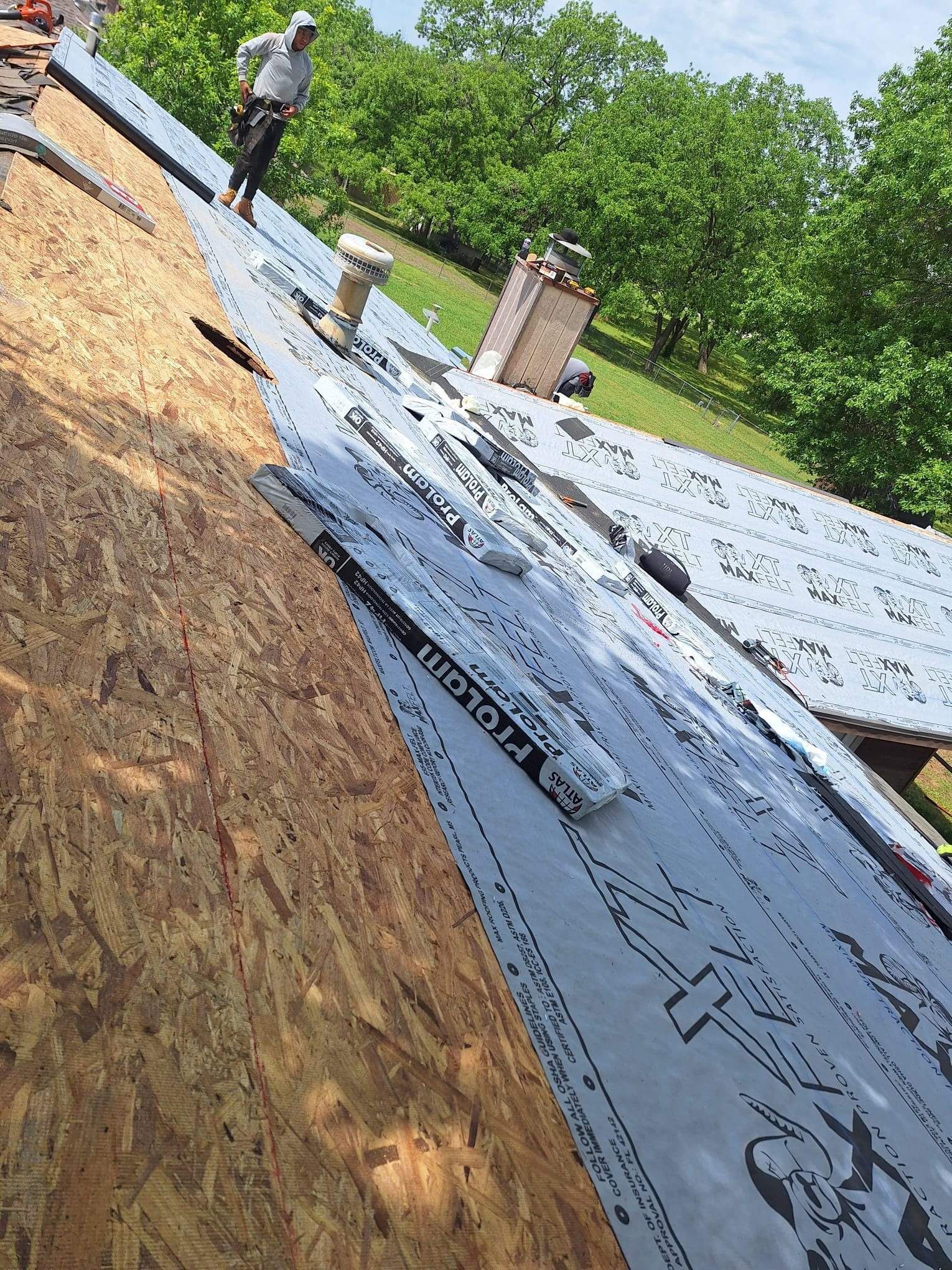 A man is working on the roof of a house.