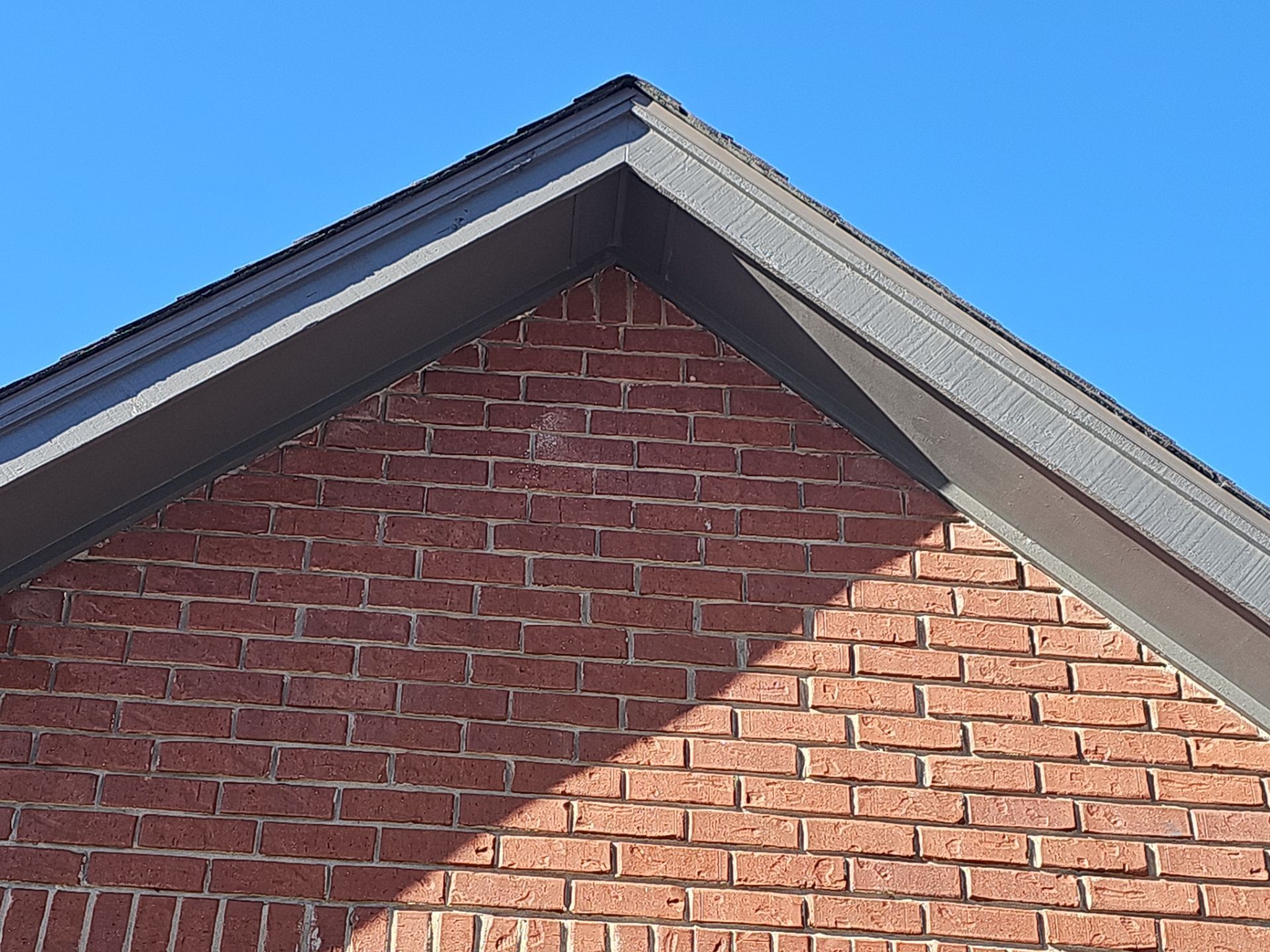 A brick building with a blue sky in the background