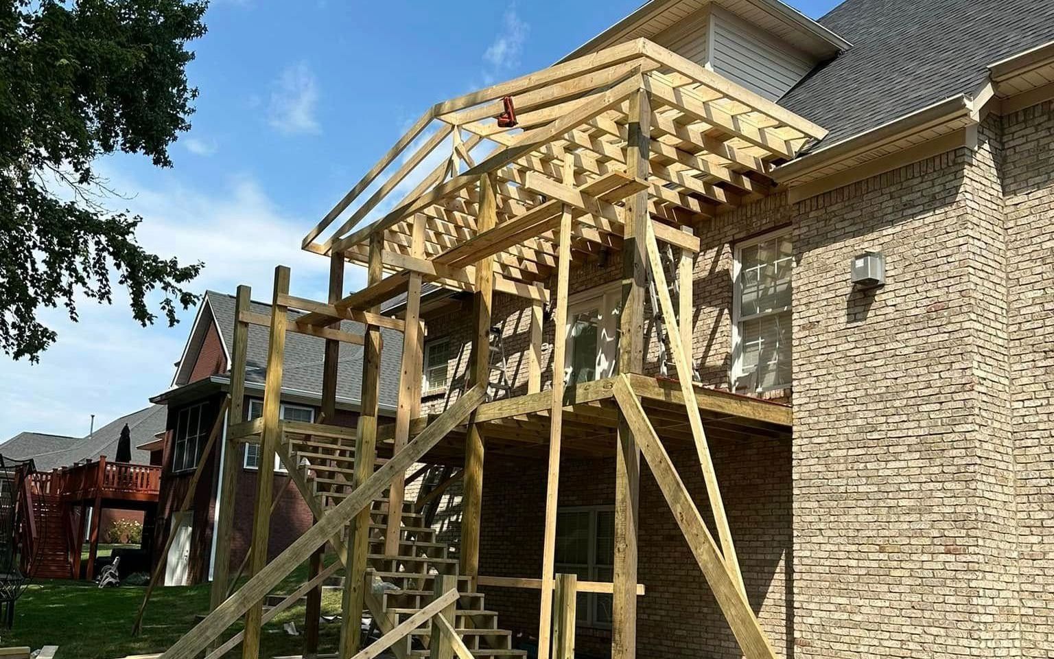 A house with a covered porch and a wooden railing.