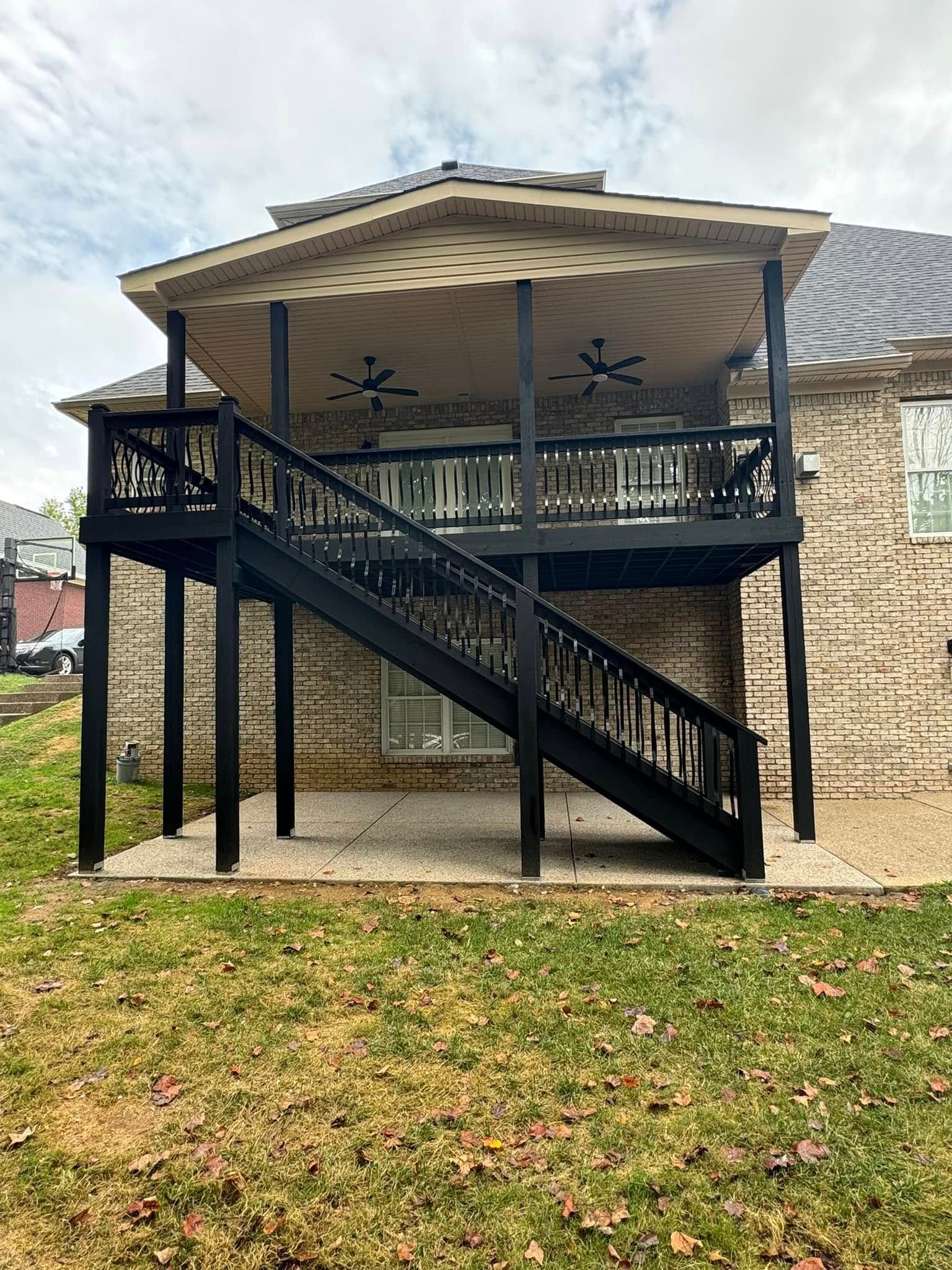 A house with a large deck and stairs leading up to it.