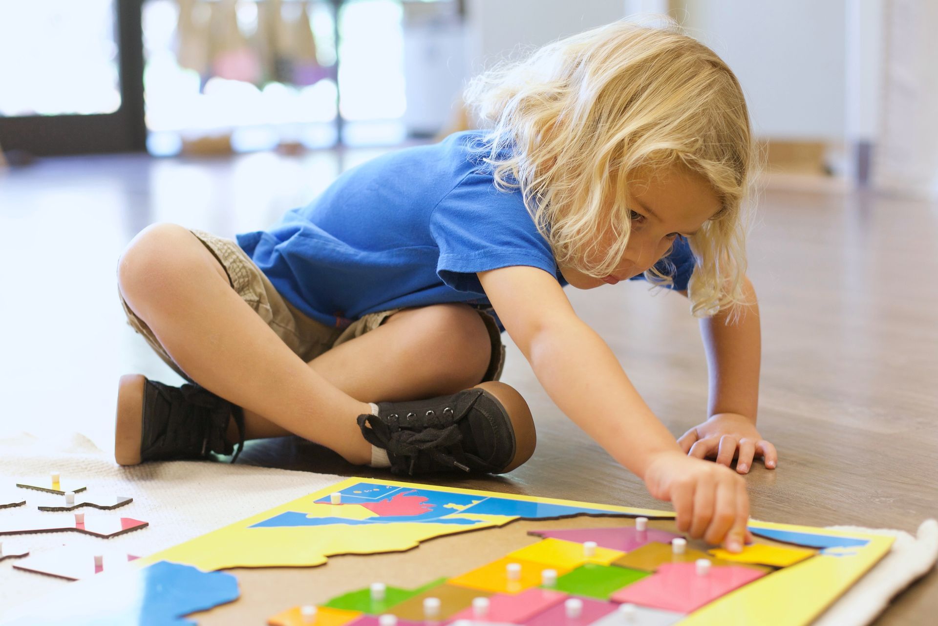 a Montessori child is holding a large sunflower in her hands