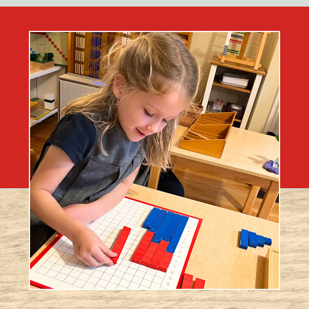 a Montessori child is sitting at a table playing with blocks