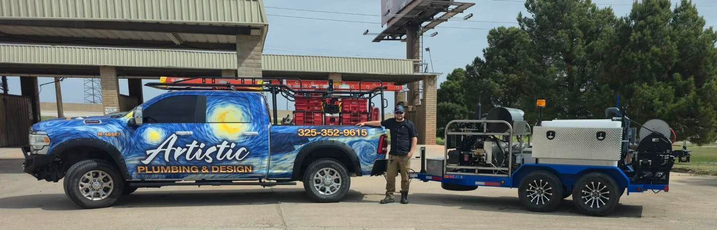 Blue decorated truck towing a blue trailer parked beside a building, with two people standing nearby.