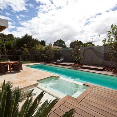 A large swimming pool is surrounded by a wooden deck — Azure Pools Mid North Coast In Taree, NSW