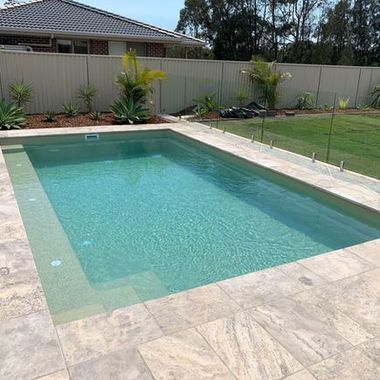 A large swimming pool in a backyard with a house in the background — Azure Pools Mid North Coast In Taree, NSW