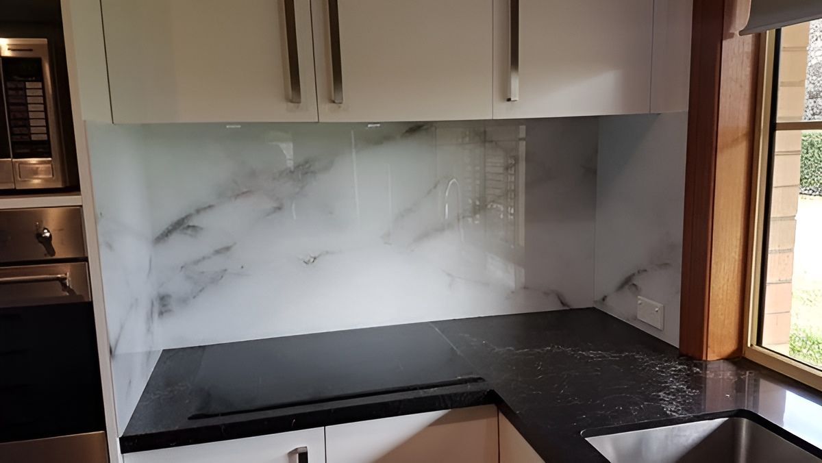 A Kitchen With White Cabinets, a Black Counter Top, a Stove Top Oven, and a Sink — DecoGlaze in Minchinbury, NSW