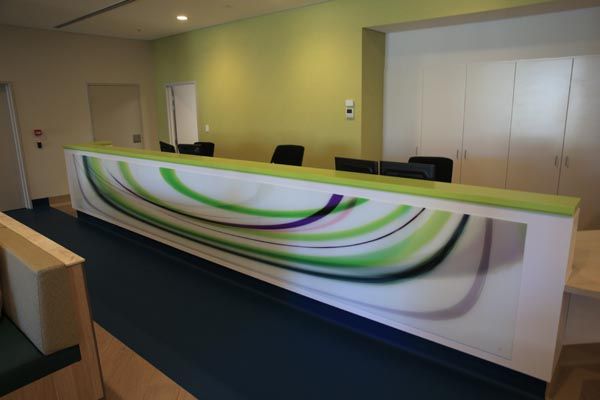 A Long Green and White Reception Desk With a Painting on It — DecoGlaze in Penrith, NSW