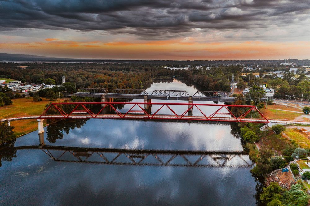 An Aerial View of a Red Bridge Over a River — DecoGlaze in Penrith, NSW