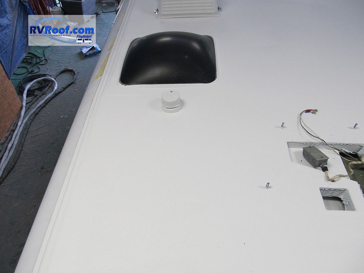 A white counter top with a black sink and a sign that says rvboot.com