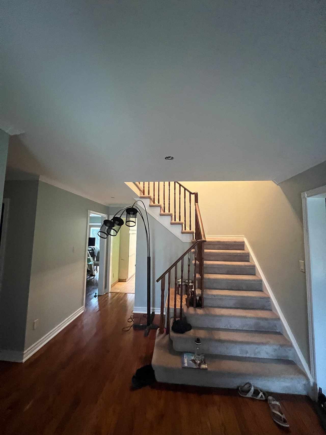 A hallway with stairs leading up to the second floor of a house.