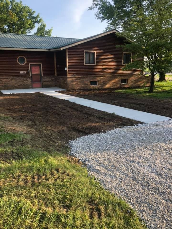 A man wearing a hard hat and goggles is standing in a room.