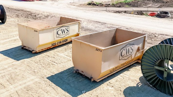 SiteLine Services roll-off dumpsters at a West Texas construction site