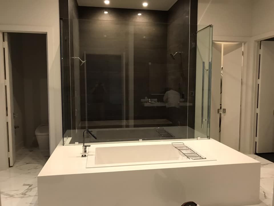 A bathroom with a bathtub and a walk in shower.