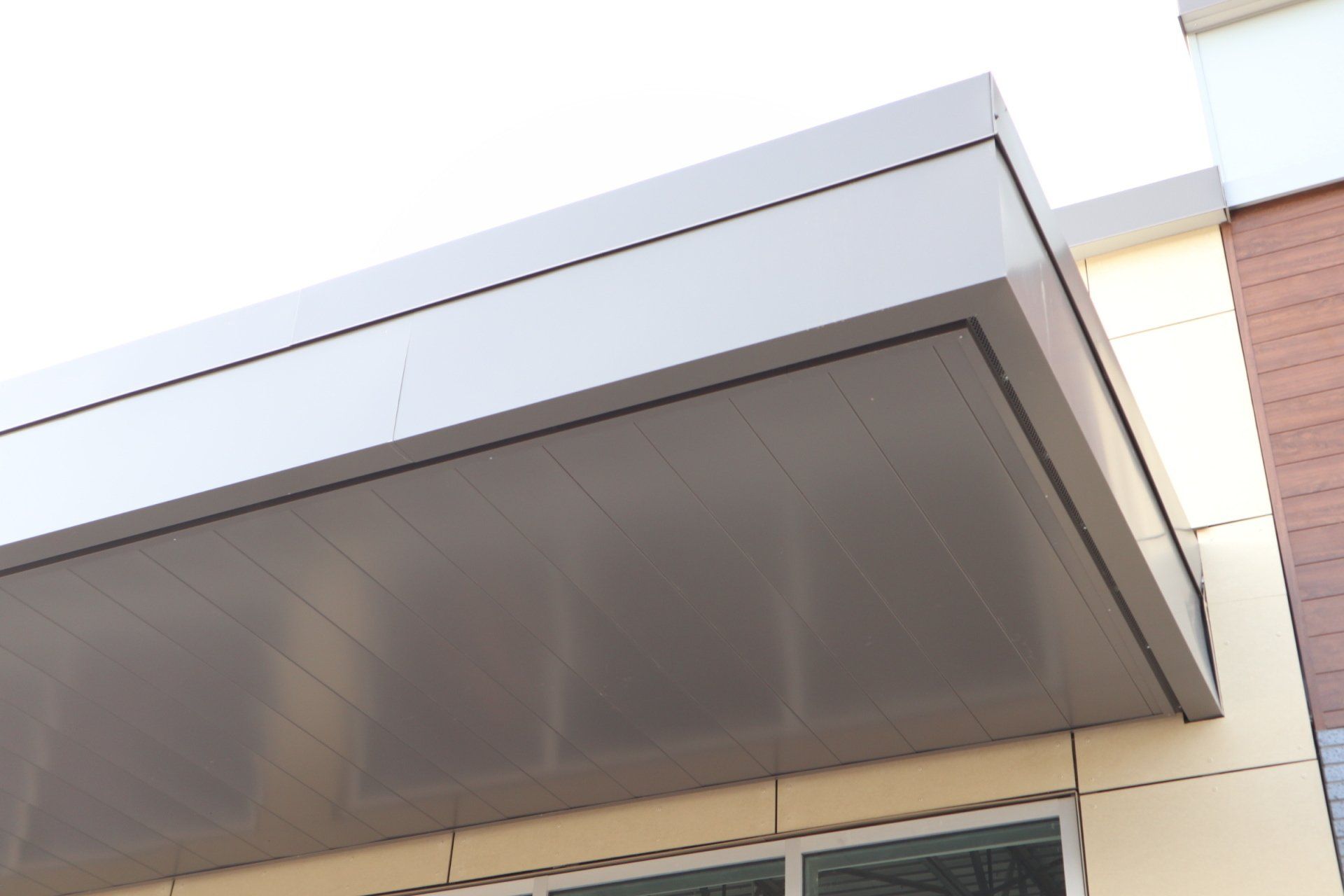 a roof of a building with a window and a canopy