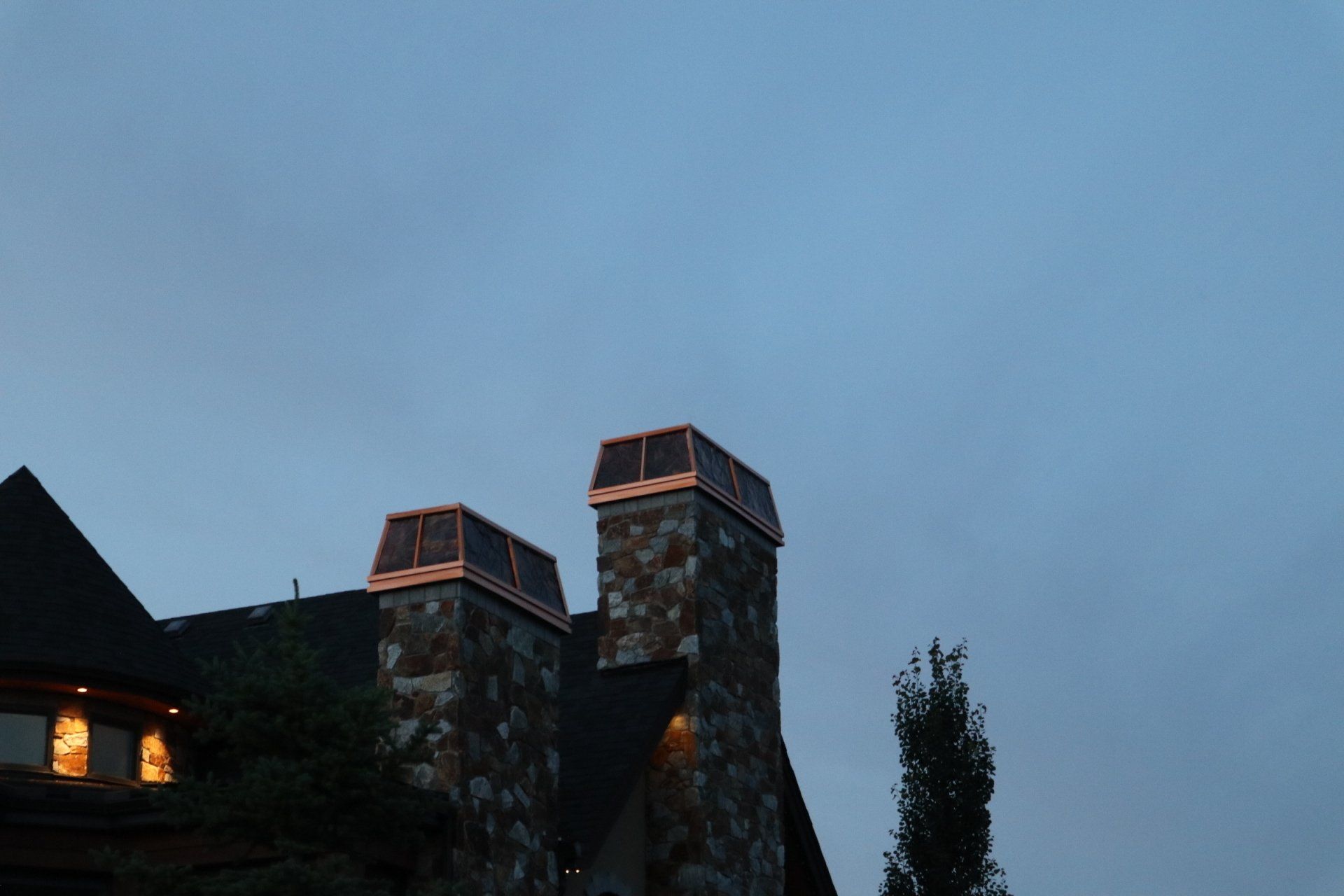a house with two chimneys on top of it