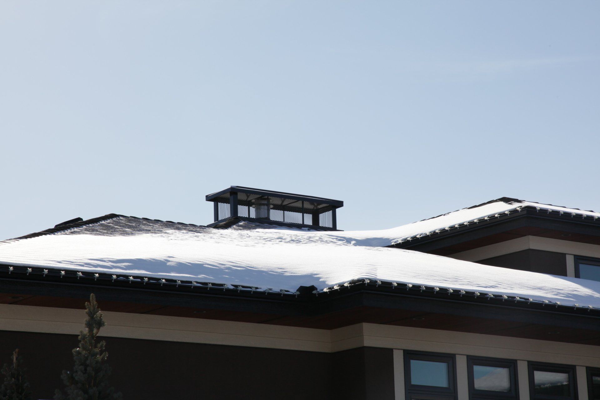 a house with snow on the roof and a chimney