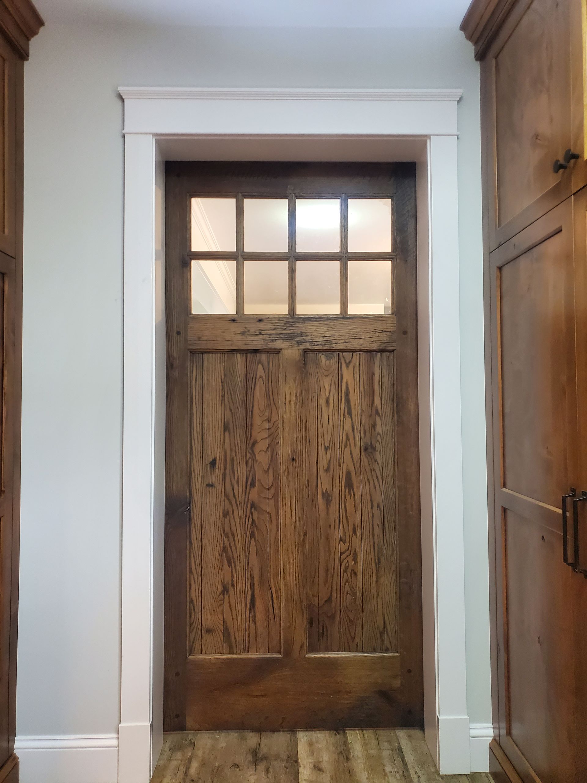 A Wooden Door with A Glass Window in A Hallway | Narvon, PA | JDH Custom Millwork
