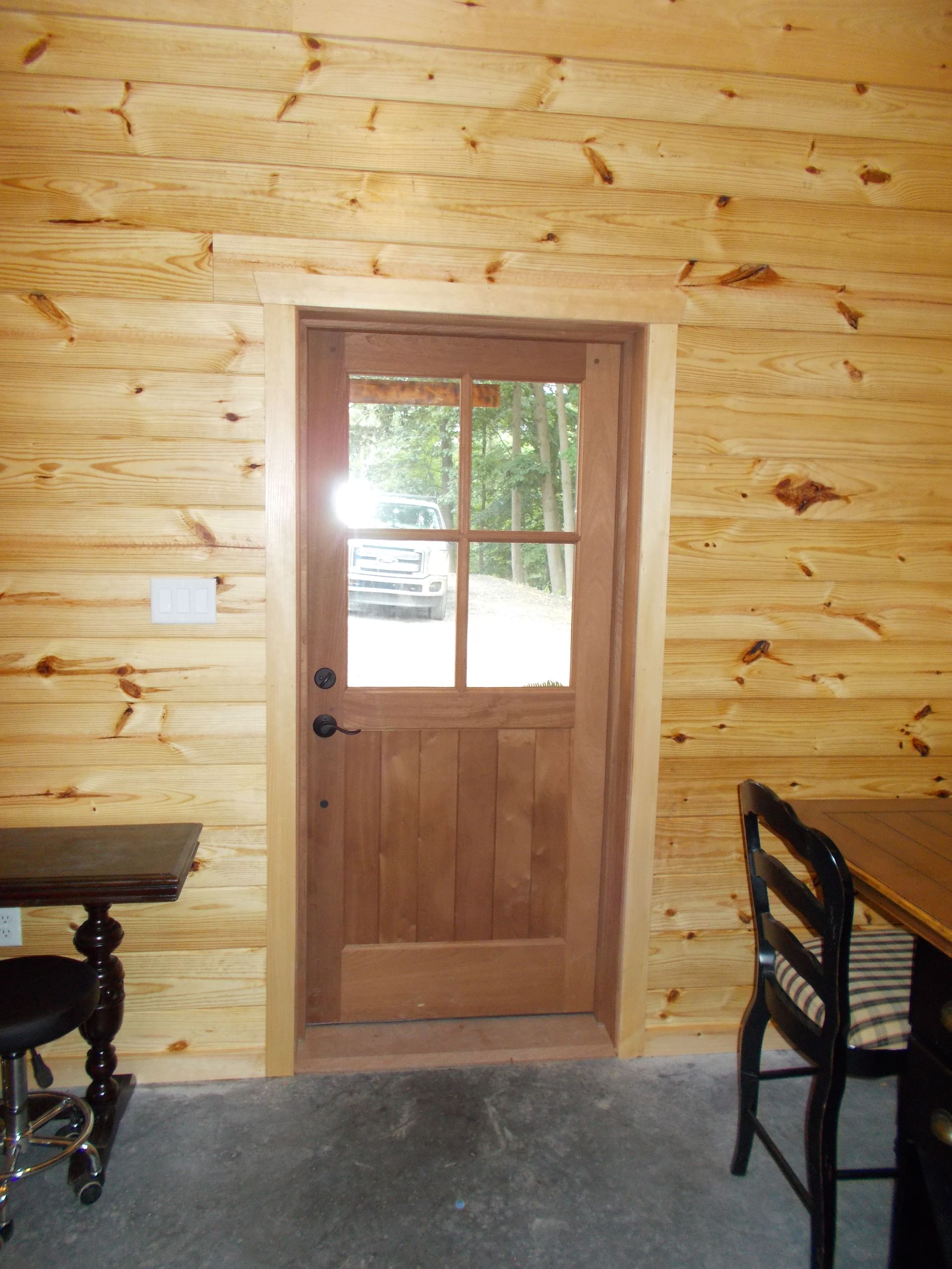 A Wooden Door in A Room with A Table and Chairs | Narvon, PA | JDH Custom Millwork