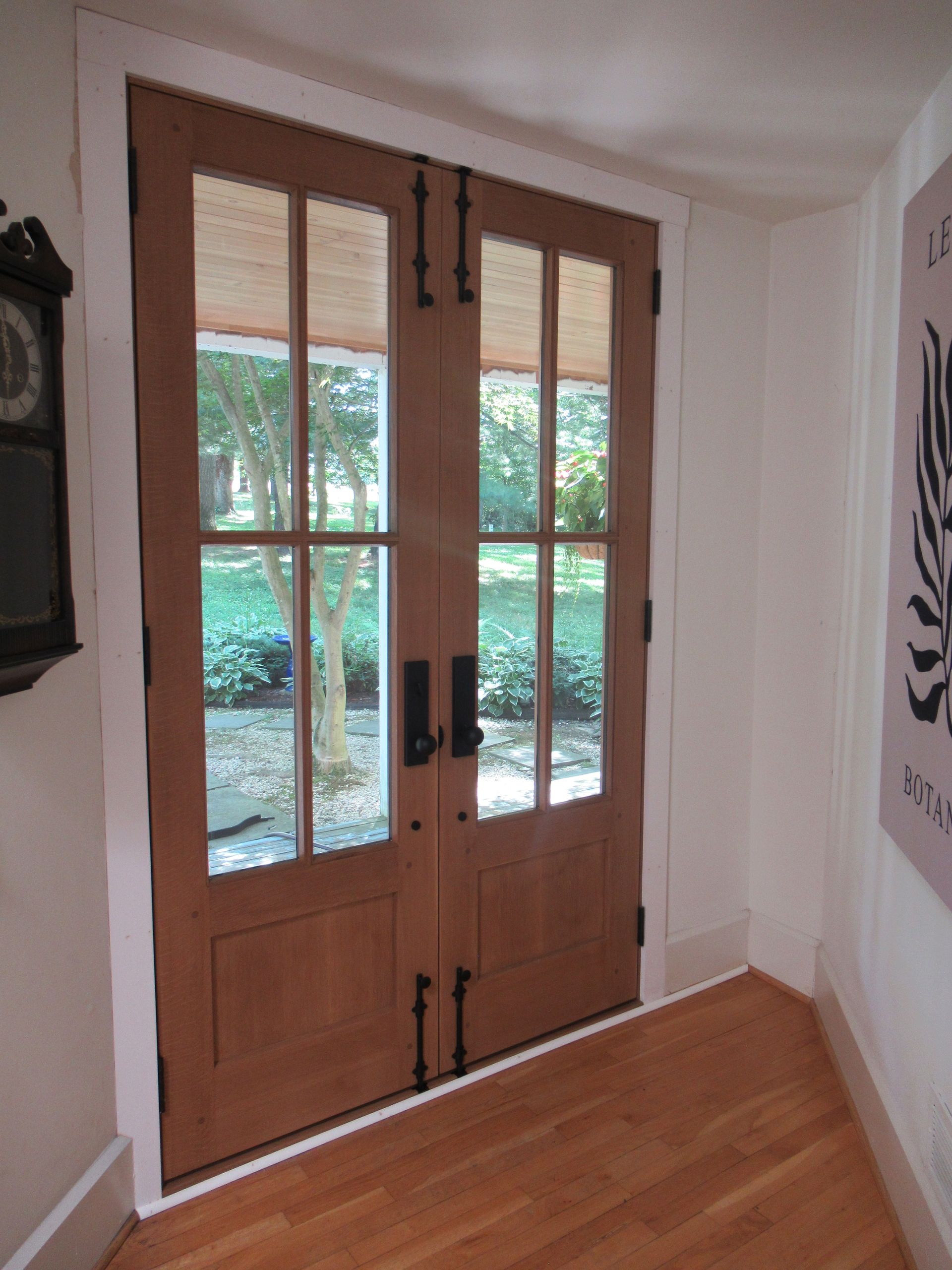 A Wooden Door with A Clock on The Wall Behind It | Narvon, PA | JDH Custom Millwork