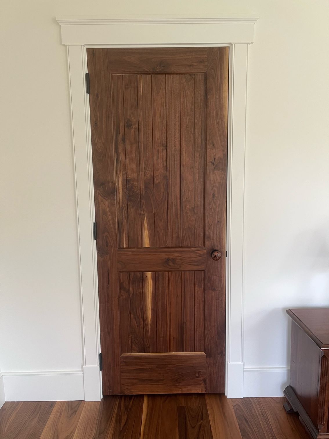 A Wooden Door with A White Trim Is in A Room with Hardwood Floors | Narvon, PA | JDH Custom Millwork