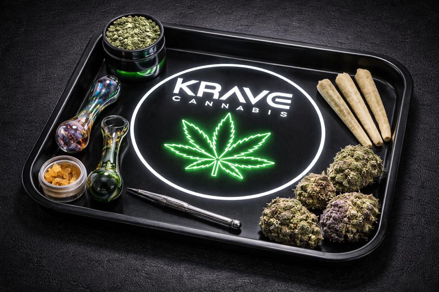 Cannabis tray with KRAVE logo, green leaf graphic, rolling papers, grinder, jars, and buds on black surface